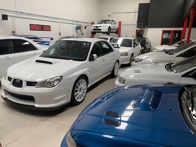 A group of cars parked in a garage.