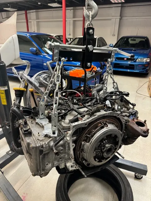 A car engine being worked on in a garage.