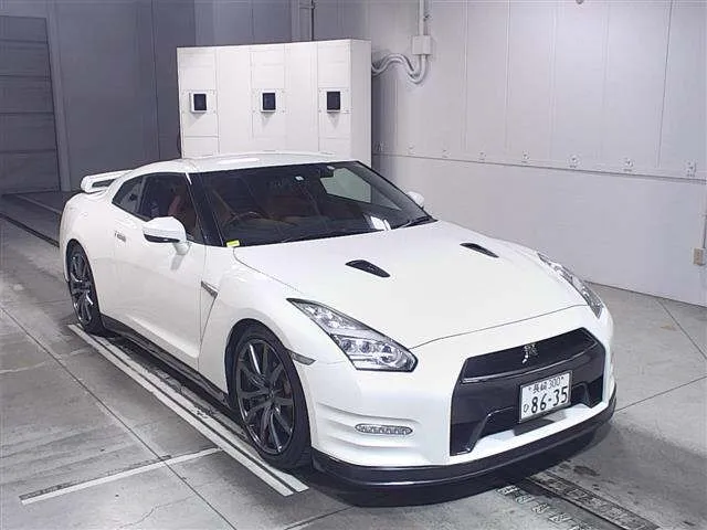 A white sports car parked in a garage.